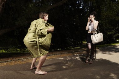 Exhibitionist attacking lady in park clipart