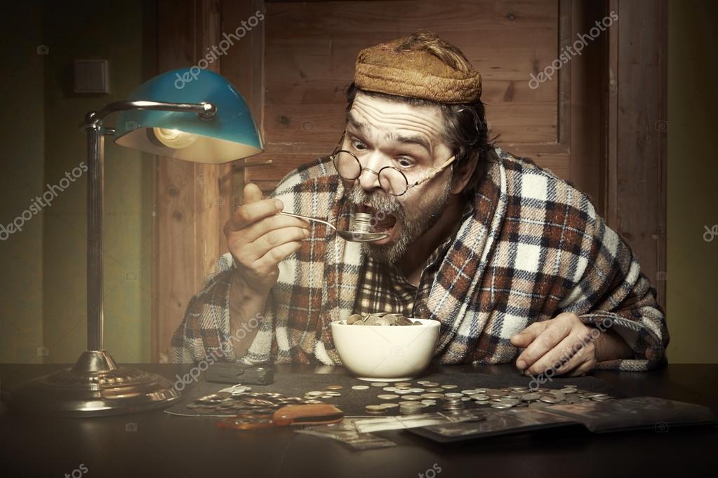 Man eating a lot of coins Stock Photo by ©Couperfield 117311542