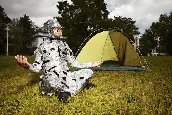 Meditating man wrapped in alu foil — Stock Photo, Image