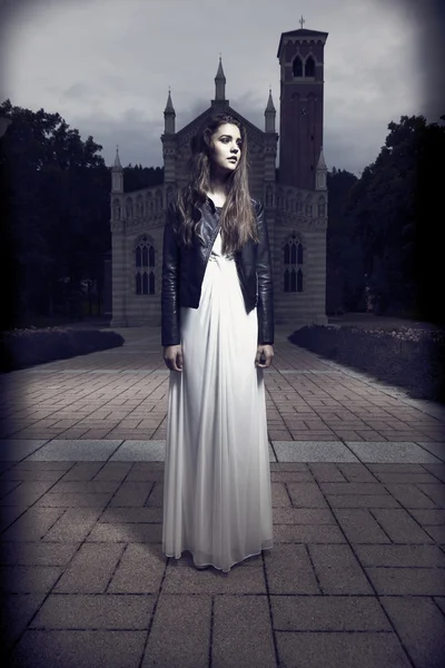 Nice dark lady posing in front of church — Stock Photo, Image