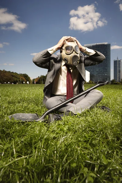 Manager in gas mask with spade