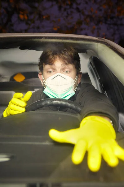 Car driver crazy of coronavirus with mask and disinfectant