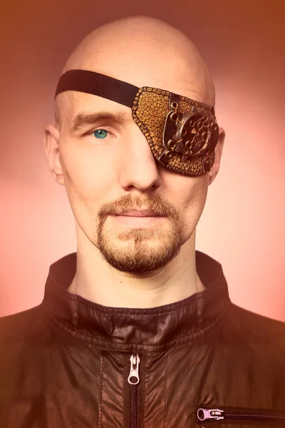 Young man in style of steampunk icon with eye patch