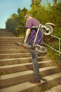 Older man overcoming obstacles with his four wheel rollator walker