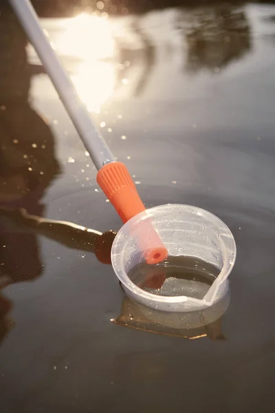 Detail of sampling beaker used for water samples collecting