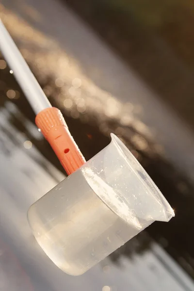 Detail of sampling beaker used for water samples collecting