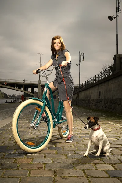 Nice girl and dog on bank — Stock Photo, Image