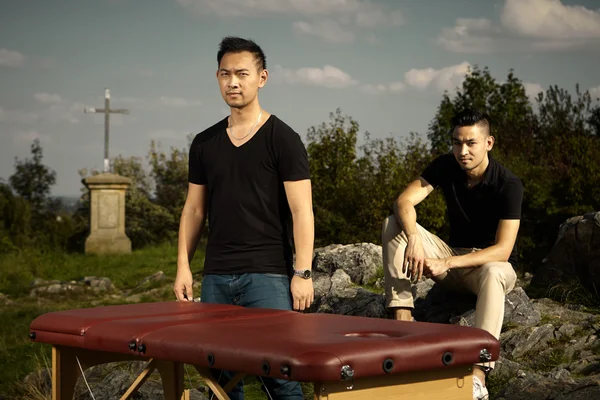 Two masseurs with massage table — Stock Photo, Image