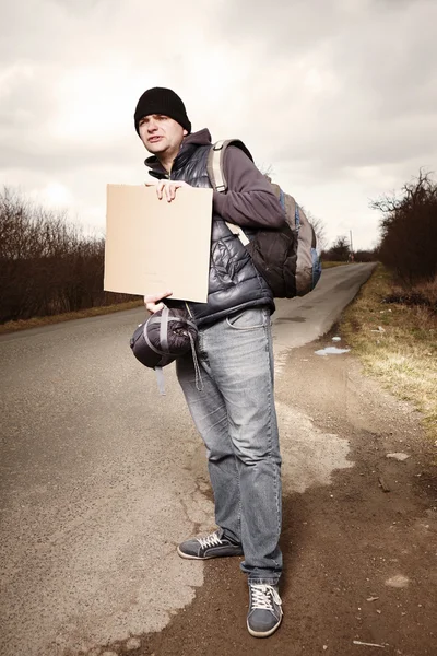 Hitch-hiker waiting for car on route — Stock Photo, Image