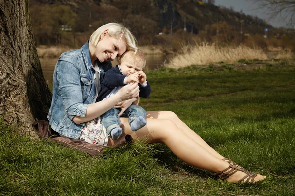 Nice woman and son relaxing in park — Stock Photo, Image