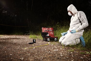 Crime scene technician at work on place