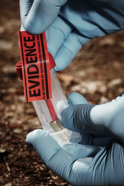 Pistol cartridge on forest way — Stock Photo, Image