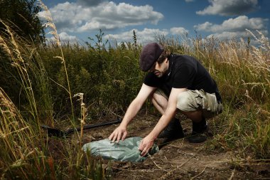 Man hiding siutcase of drugs