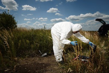 Criminologist technician working on hiding place