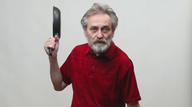 Yaşı ilerlemiş yaşlı bir adam arka planda izole edilmiş tabancayla operasyon yapıyor.