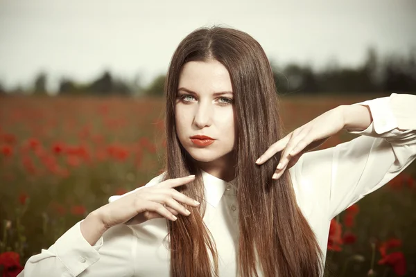 Pretty girl in field of red poppy — Stock Photo, Image