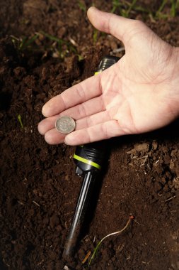 Man found a coin in fields clipart
