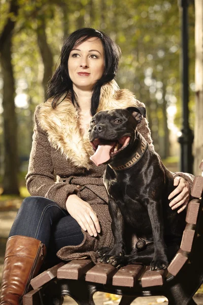 Pretty woman and dog in park — Stock Photo, Image