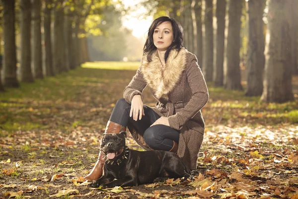 Nice lady and her dog in park — Stock Photo, Image