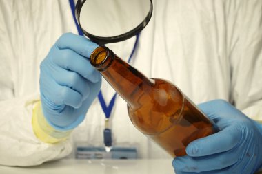 In crime lab - fingerprints on bottle clipart