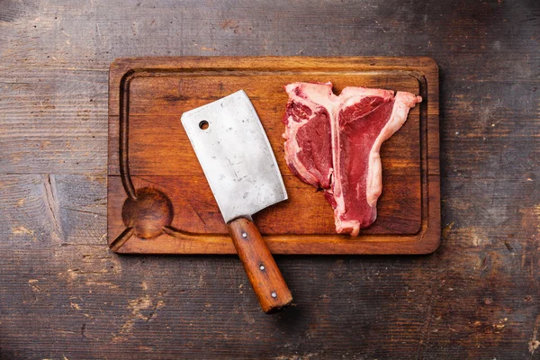 Raw fresh meat T-Bone Steak and meat cleaver