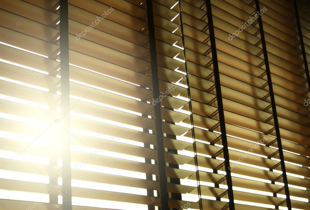 Blinds in a home catching the sunlight with burst light