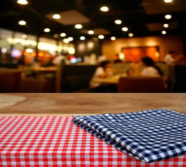 checkered tablecloth and customer at restaurant blur background with bokeh