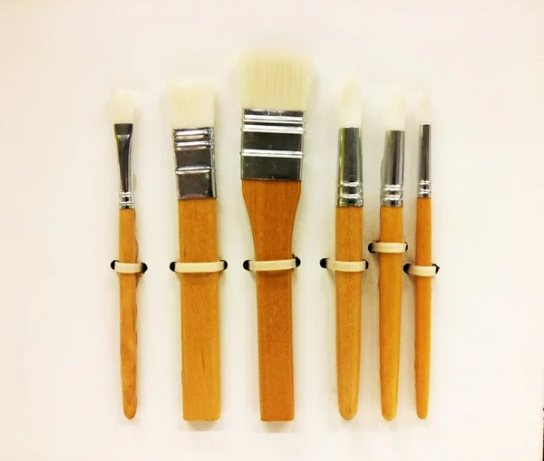 Paint brushes on wall — Stock Photo, Image