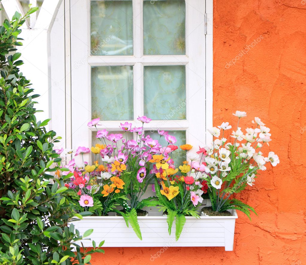Flower box in window of orange building