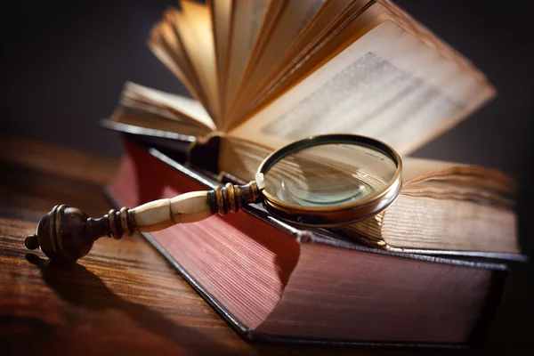 Old book and magnifying glass — Stock Photo, Image