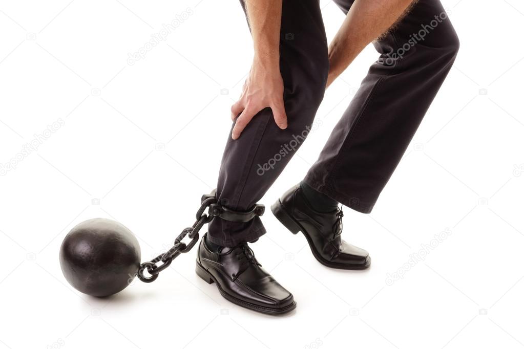 Ball and chain restraining businessman