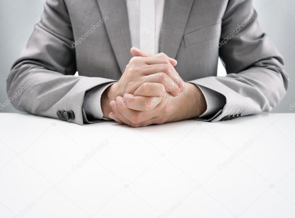 Business interview with hands clasped