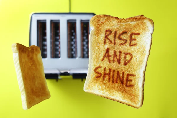 Guten Morgen Aufstieg und Glanz auf fliegendem Toast oder Toastbrot, das aus dem Toaster auftaucht — Stockbild Aufstieg und Glanz Toastbrot — Stockfoto