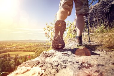 Hiker hiking on a mountain trail  clipart