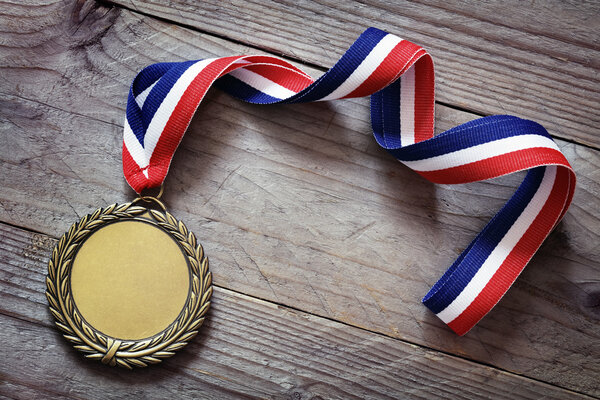 Gold medal on wood background