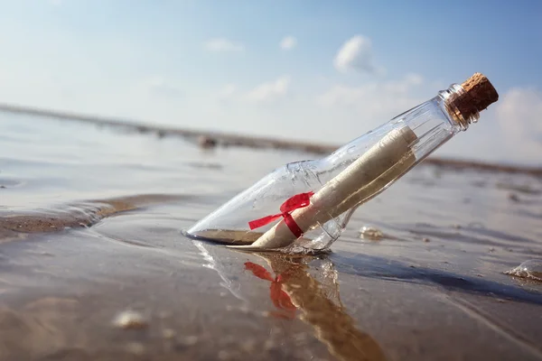 Flaskpost spolats upp på en strand — Stockfoto