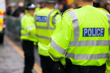 Police in hi-visibility jackets policing crowd control at a UK event clipart