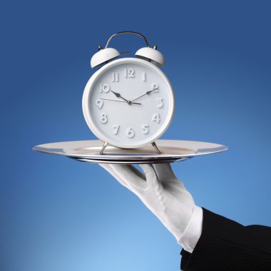 Waiter holding platter with clock clipart