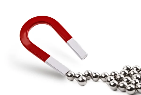 Magnet attracting chrome ball bearing — Stock Photo, Image