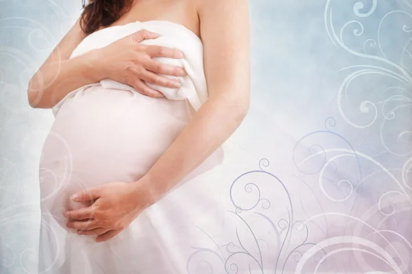 Pregnant woman holding her belly — Stock Photo, Image