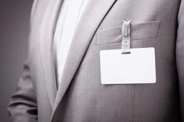 Businessman wearing blank name tag — Stock Photo, Image