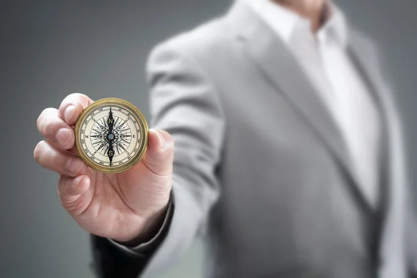 Businessman holding compass — Stock Photo, Image