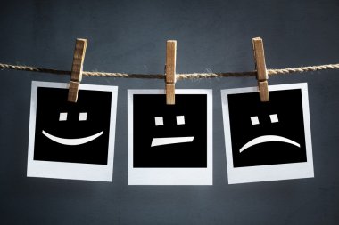 Happy, sad and neutral emoticons on instant print photographs clipart