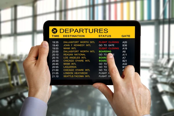 Digital tablet in airport with flight information — Stock Photo, Image