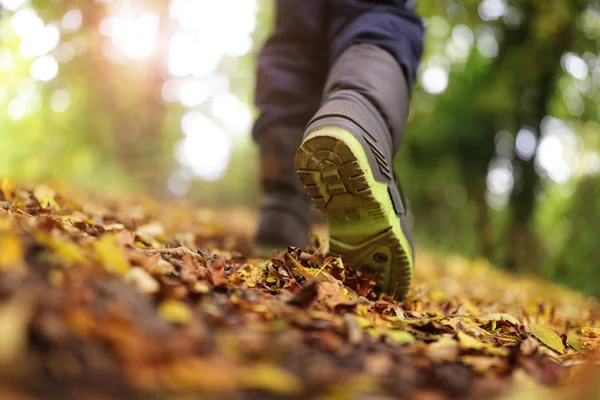 Boy walking on footpath — Stock Photo, Image