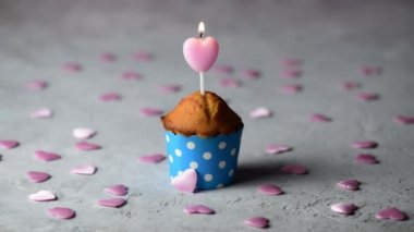 4k Sevgililer Günü keki ya da küçük pembe kalplerle gri bir arka planda pembe kalp şeklinde mum mumlu kek, Sevgililer Günü kutlamaları. Tatil, evli çiftin yıldönümü, doğum günü.
