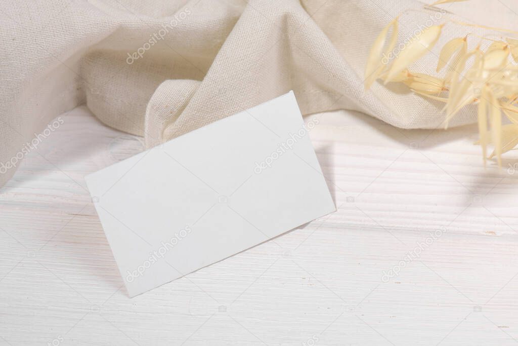 Business card mockup template, empty stationery card with dry plants flower and natural linen on a white background and design element for wedding invitation, rsvp, thank you card, greeting