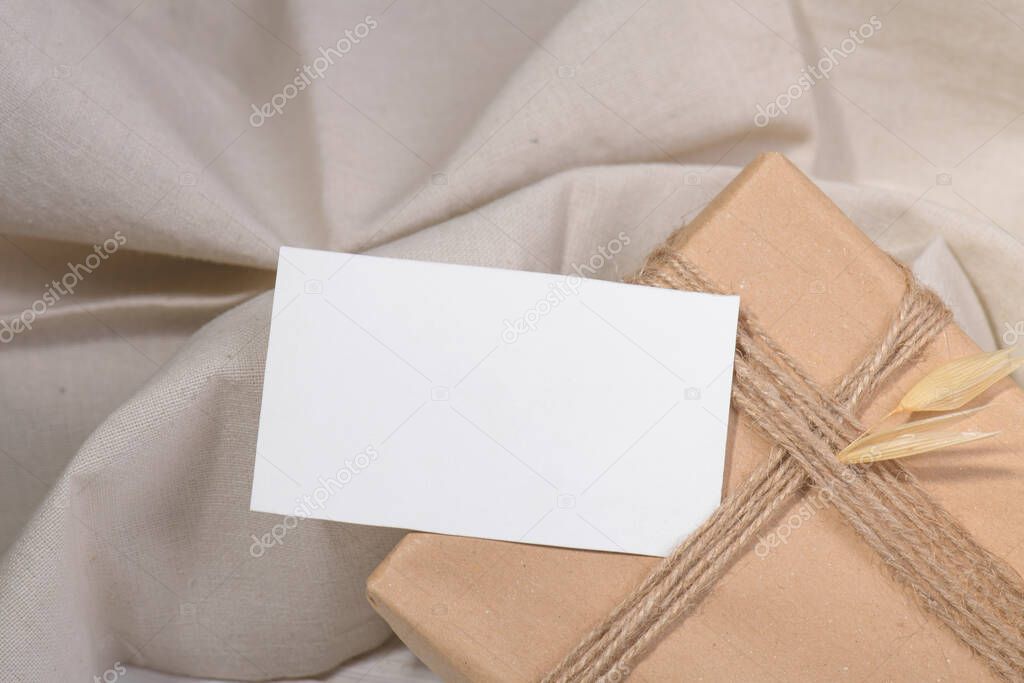 Business card mockup template, empty stationery card with dry plants flower and natural linen on a white background and design element for wedding invitation, rsvp, thank you card, greeting