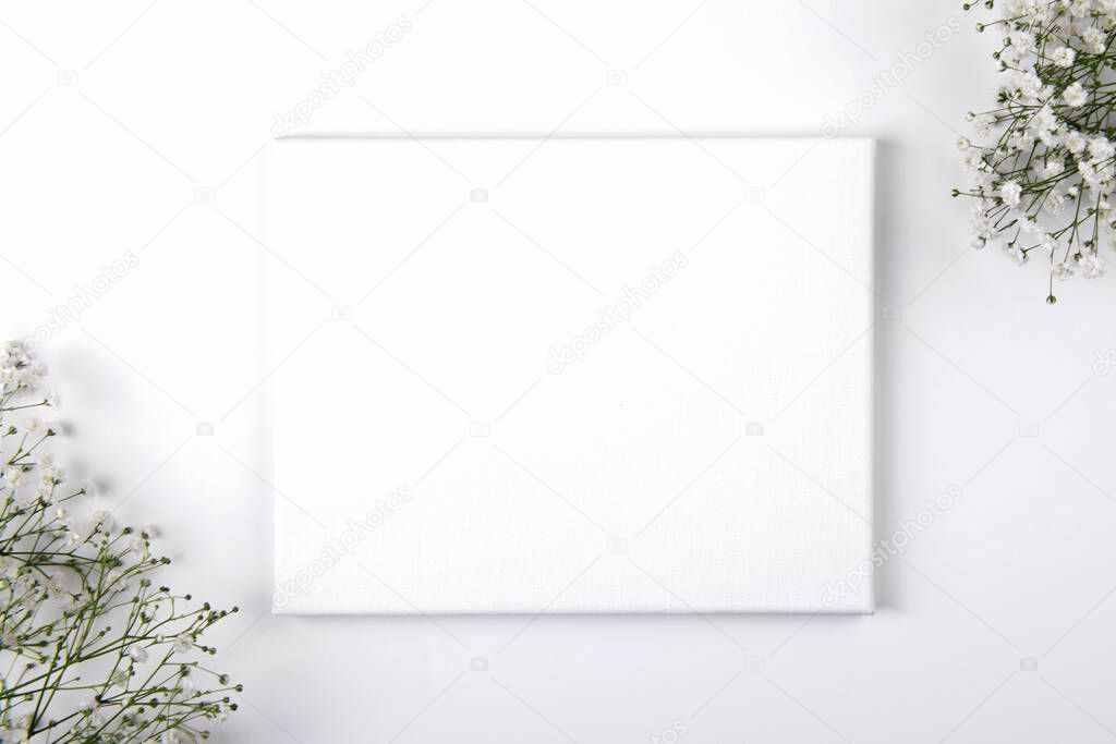 Canvas mockup with smal white flowers on a white background. Design element for Valentines Day and Mother Day congratulation, thank you, greeting or invitation card, art work