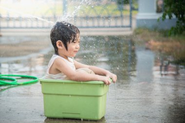 Çocuk suda oynarken eğlenceli